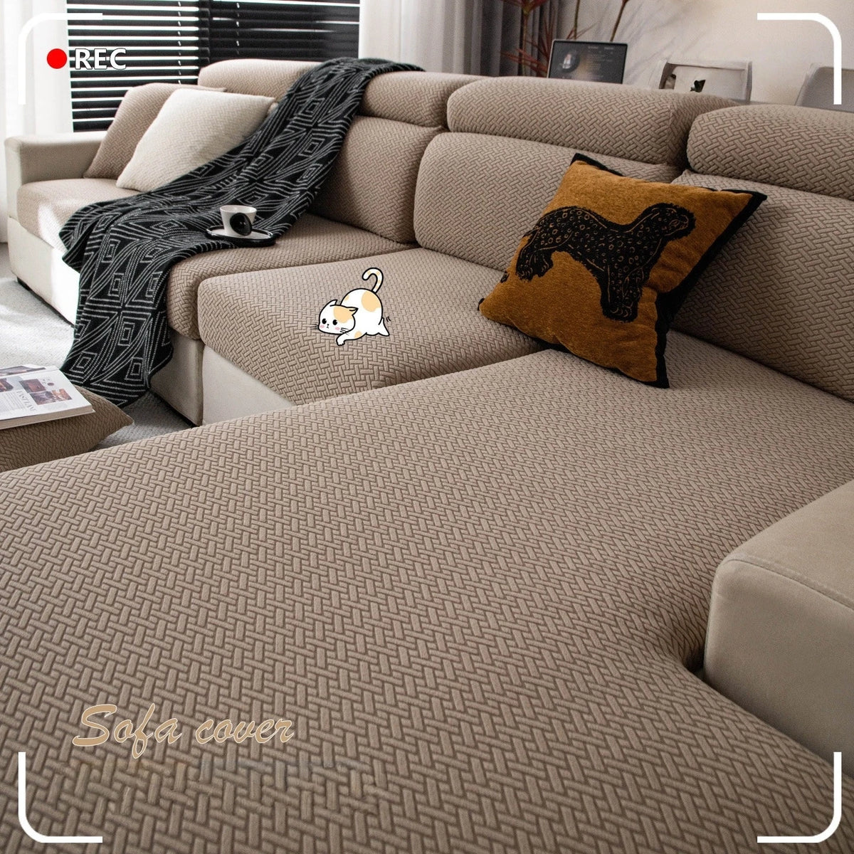 A beige stretchy polar fleece sofa cover with a patterned throw and decorative pillows on a sectional sofa.