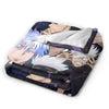 A flannel throw blanket featuring artwork of Gojo Satoru from Jujutsu Kaisen