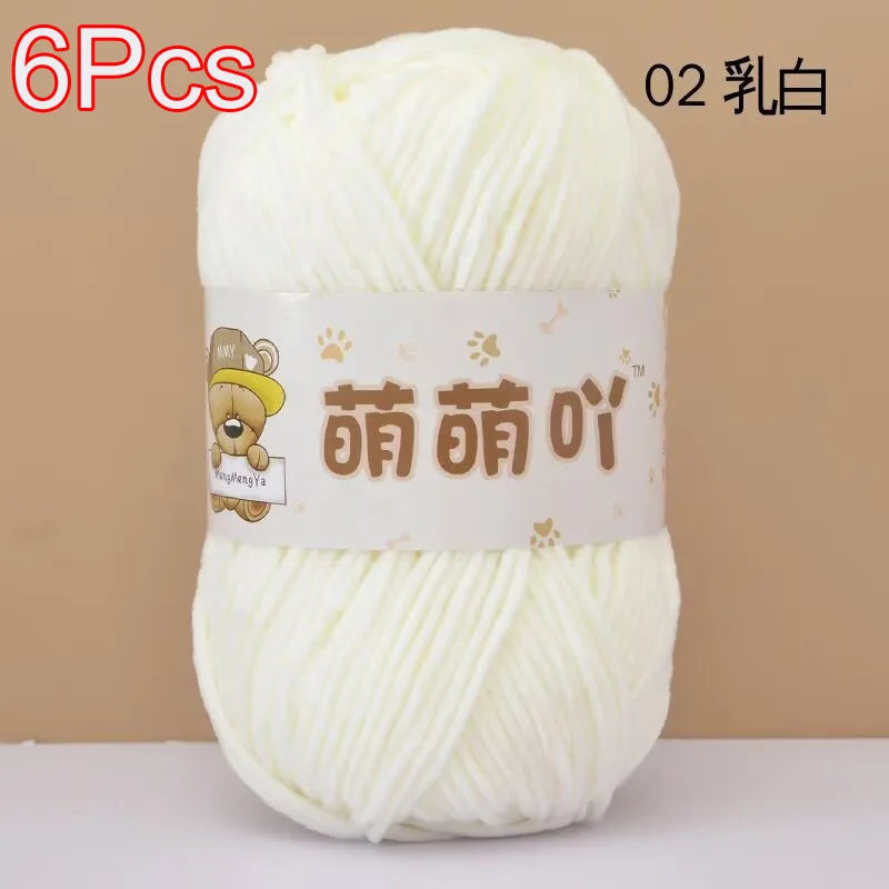 A ball of white soft bulky chenille yarn labeled for crochet and knitting projects.
