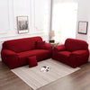 A deep red faux silk sofa cover is displayed on a light rug in a bright room.