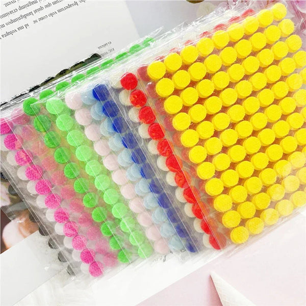 A sheet of multi-color self-adhesive hook and loop fastener tape with various colored strips.