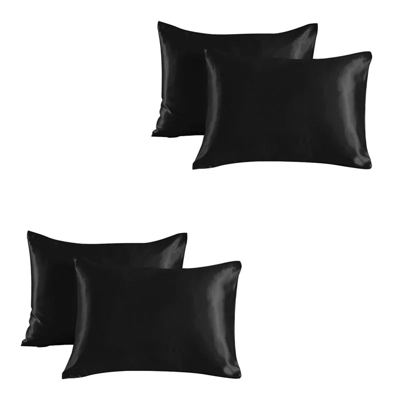 A set of two black satin silk pillowcases.