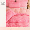 A set of pink fluffy bedding including pillows and a duvet cover, emphasizing soft skin-friendly and breathable features.