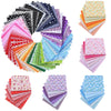 A collection of colorful floral dot pattern cotton fabric squares arranged in a circular display.
