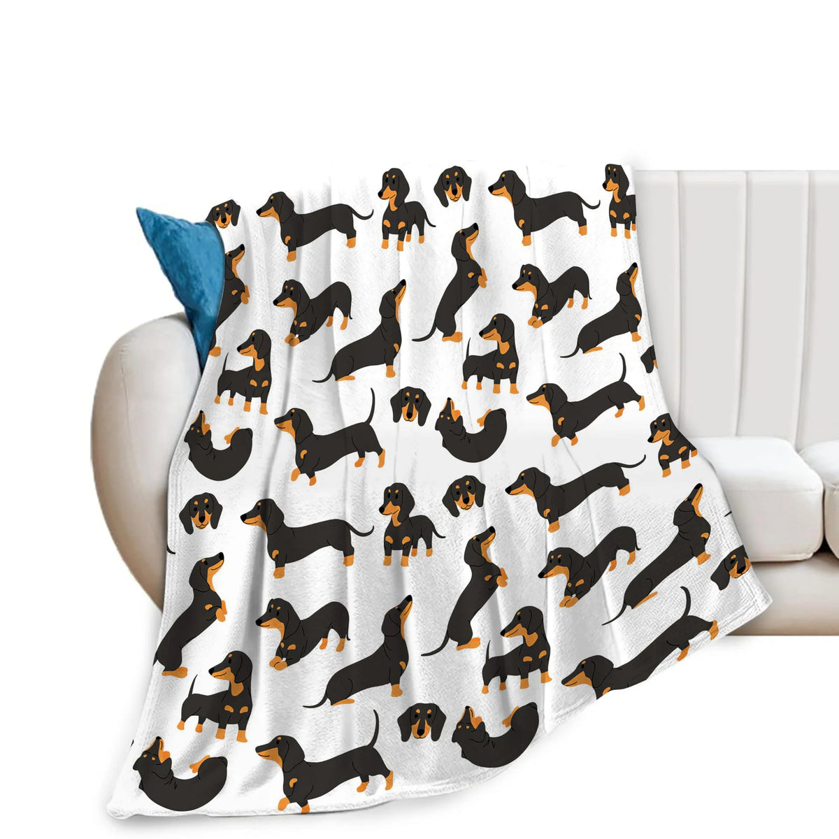 A white flannel blanket featuring a repeating pattern of black and orange dachshund silhouettes.