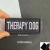 Black embroidered patch with white text Therapy Dog measuring 9cm or 3.54inch wide