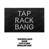 Black embroidered patch with white text saying TAP RACK BANG