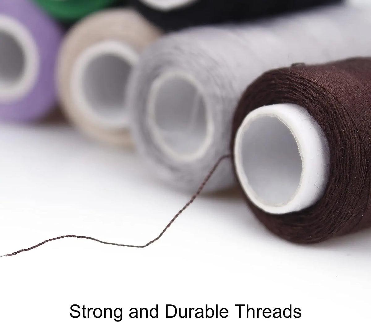 A close-up of various colored polyester sewing threads rolled on a spool, with a single strand extending out.