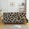A black and cream floral patterned velvet sofa cover displayed on a wooden frame.