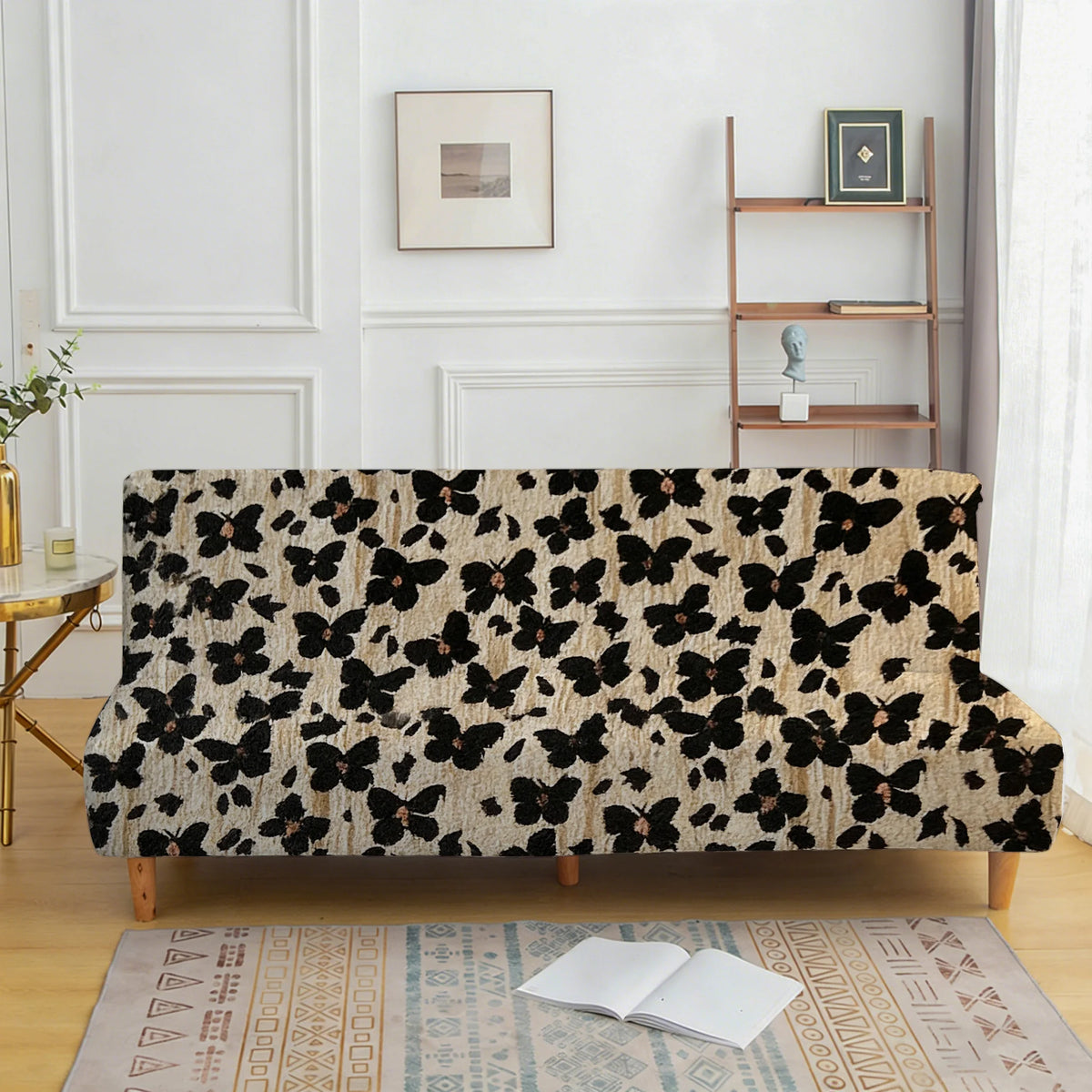 A black and cream floral patterned velvet sofa cover displayed on a wooden frame.