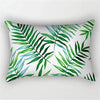 A square pillowcase featuring a tropical leaf print design in shades of green and blue.