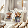 A decorative pillow cover featuring an adorable Highland cow print with flowers and foliage.