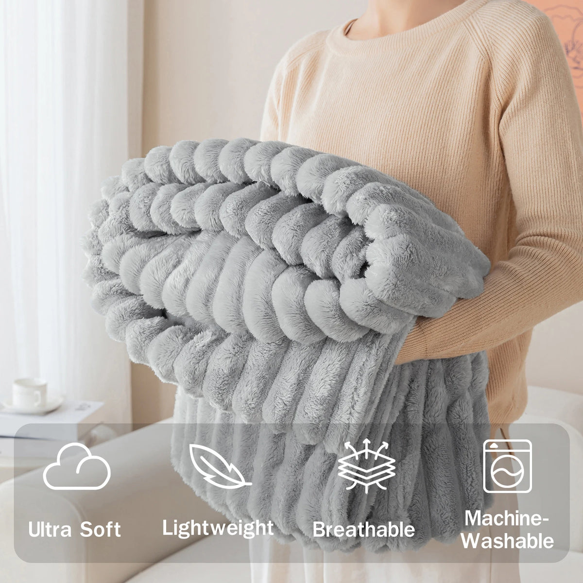 A person is holding a fluffy gray soft flannel throw blanket, highlighting its ultra soft, lightweight, breathable, and machi