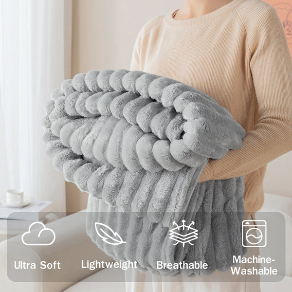 A person is holding a fluffy gray soft flannel throw blanket, highlighting its ultra soft, lightweight, breathable, and machi