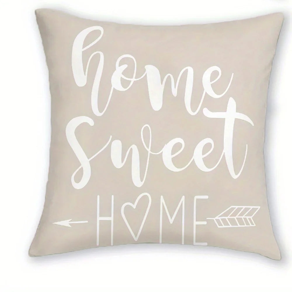 A beige decorative pillow cover with white script text that reads Home Sweet Home.