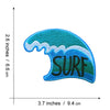 A teal and blue embroidered patch shaped like a breaking wave with the word SURF on it.