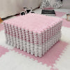 A large square play mat made of pink and white soft plush EVA foam tiles on a white rug.