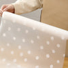 A close-up of a translucent, white silicone non-slip drawer liner with scattered white dots.