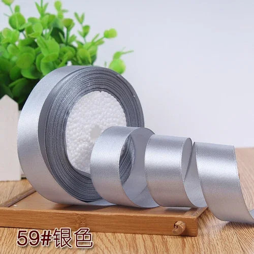 Roll of silver satin ribbon for gift wrapping and DIY crafts