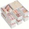 A white foldable underwear organizer set with various shades of pink and beige fabric folded inside.