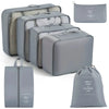 A set of gray travel storage organizers including a zippered pouch and a rectangular box.