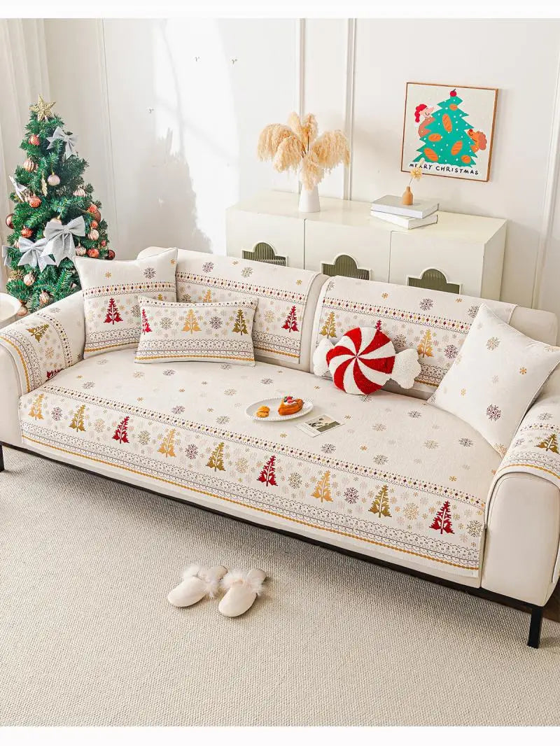 A beige sofa seat covered with festive Christmas-themed fabric featuring pine trees and ornaments.