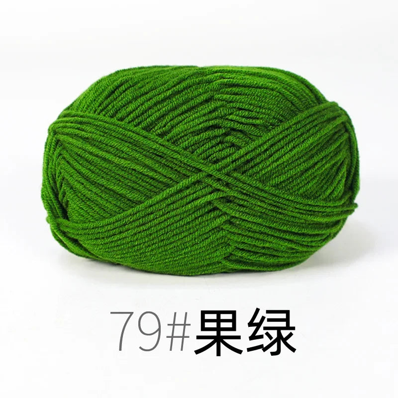 A ball of bright green organic cotton 4ply knitting yarn.