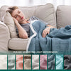 A woman relaxing on a sofa covered with a blue linen throw blanket, showing light color references below.
