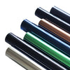 A collection of black and bronze one way mirror window film tubes showing various shades and finishes.