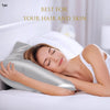 A woman is sleeping on a white pillow with a silky satin pillowcase, emphasizing its use for hair and skin.