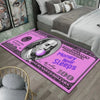 A pink anti-slip area rug featuring a $100 bill design with the text Money Never Sleeps and One Hundred Dollars