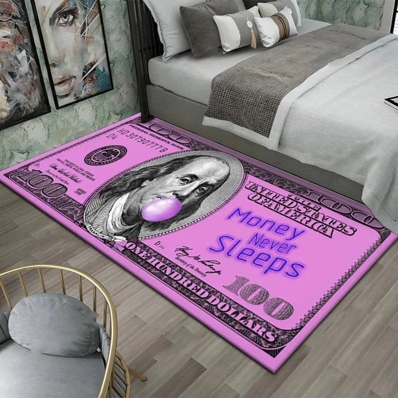 A pink anti-slip area rug featuring a $100 bill design with the text Money Never Sleeps and One Hundred Dollars