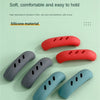 Various colored silicone pan handle covers designed to protect and make holding hot pots easier.