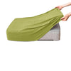 A lime green polar fleece jacquard sofa seat cushion cover being held by a hand.