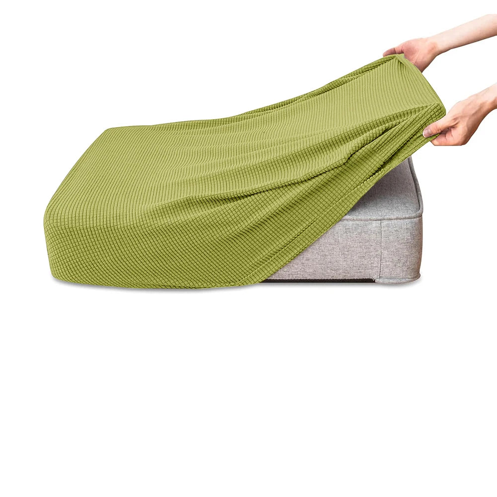 A lime green polar fleece jacquard sofa seat cushion cover being held by a hand.