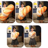 A series of plush pillows shaped like loaves of bread in various sizes, demonstrating different dimensions from 70cm to 100cm