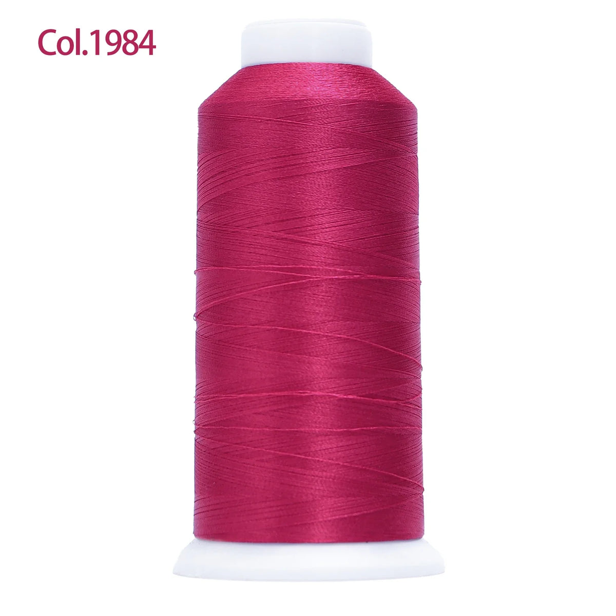 A spool of magenta embroidery thread labeled Col.1984 with a white core.