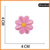 A set of 10 pink and yellow embroidered flower patches for iron-on use.