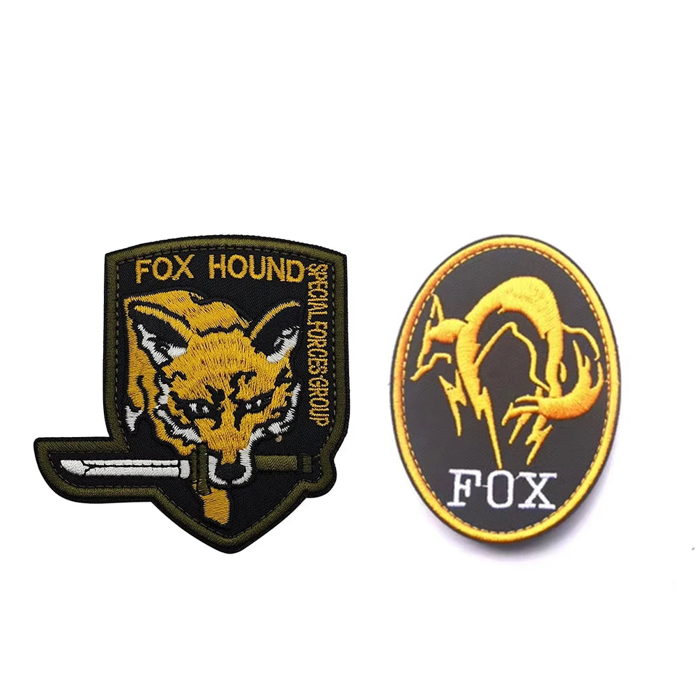 A set of two embroidered patches featuring a stylized fox head and the word FOX, used for Metal Gear Solid Foxhound uniform b