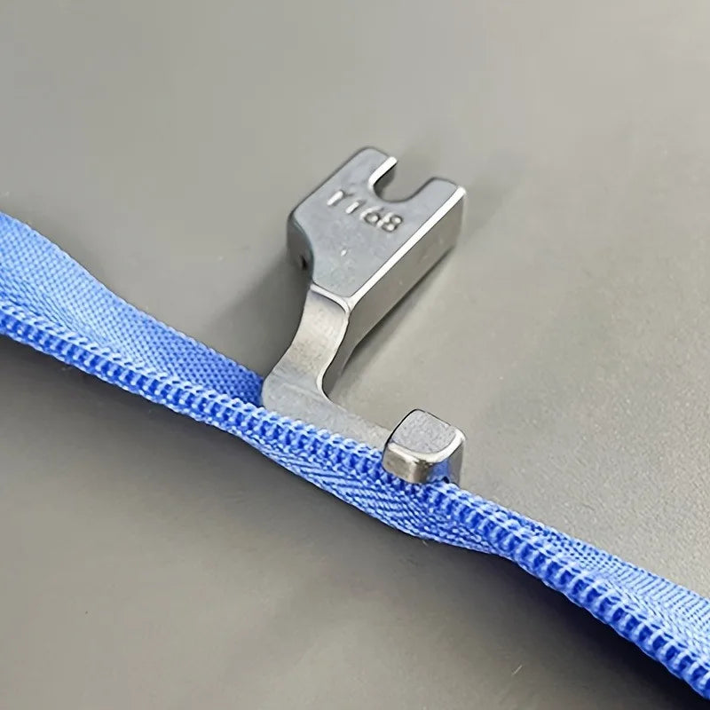A silver industrial steel presser foot with an invisible zipper is shown against a gray background.