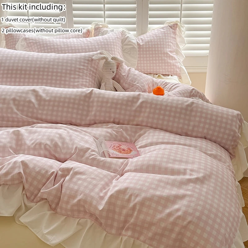 A set of pink and white lace bedding including a duvet cover, two pillowcases, and a decorative item.