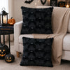 Black faux fur bat plush cushion cover used as Halloween decor on a sofa.