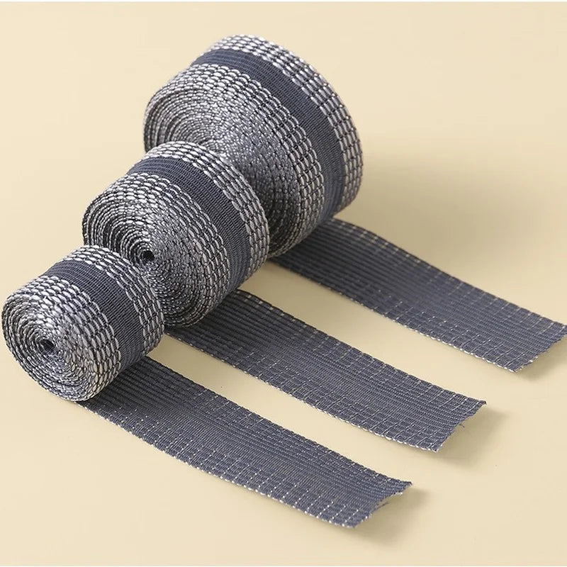 Rolls of gray self-adhesive hem tape for fabric repair and shortening