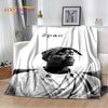 A black and white graphic throw blanket featuring a portrait of a man wearing a bandana and a shirt.