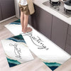 Two rectangular non-slip kitchen rugs with a diamond print featuring elegant script lettering on a white background.