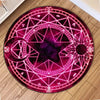 A round area rug with a vibrant magenta and purple geometric star pattern on a dark background.