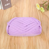 A ball of purple flat thread yarn for crafting and sewing lying on a wooden surface.