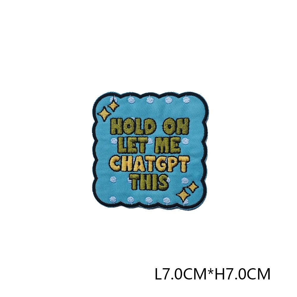 A teal embroidered patch with the text Hold on let me chatgpt this
