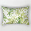 A decorative pillowcase featuring a tropical leaf print in shades of green on a white background.