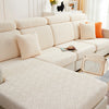 A beige jacquard plush sofa cushion cover with a geometric pattern displayed on a modern sofa.